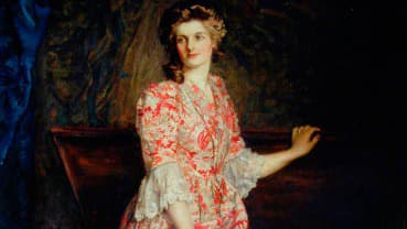 A woman, illustrated within a painting, stands next to an oak wood box with an open lid, her hand touching the top.